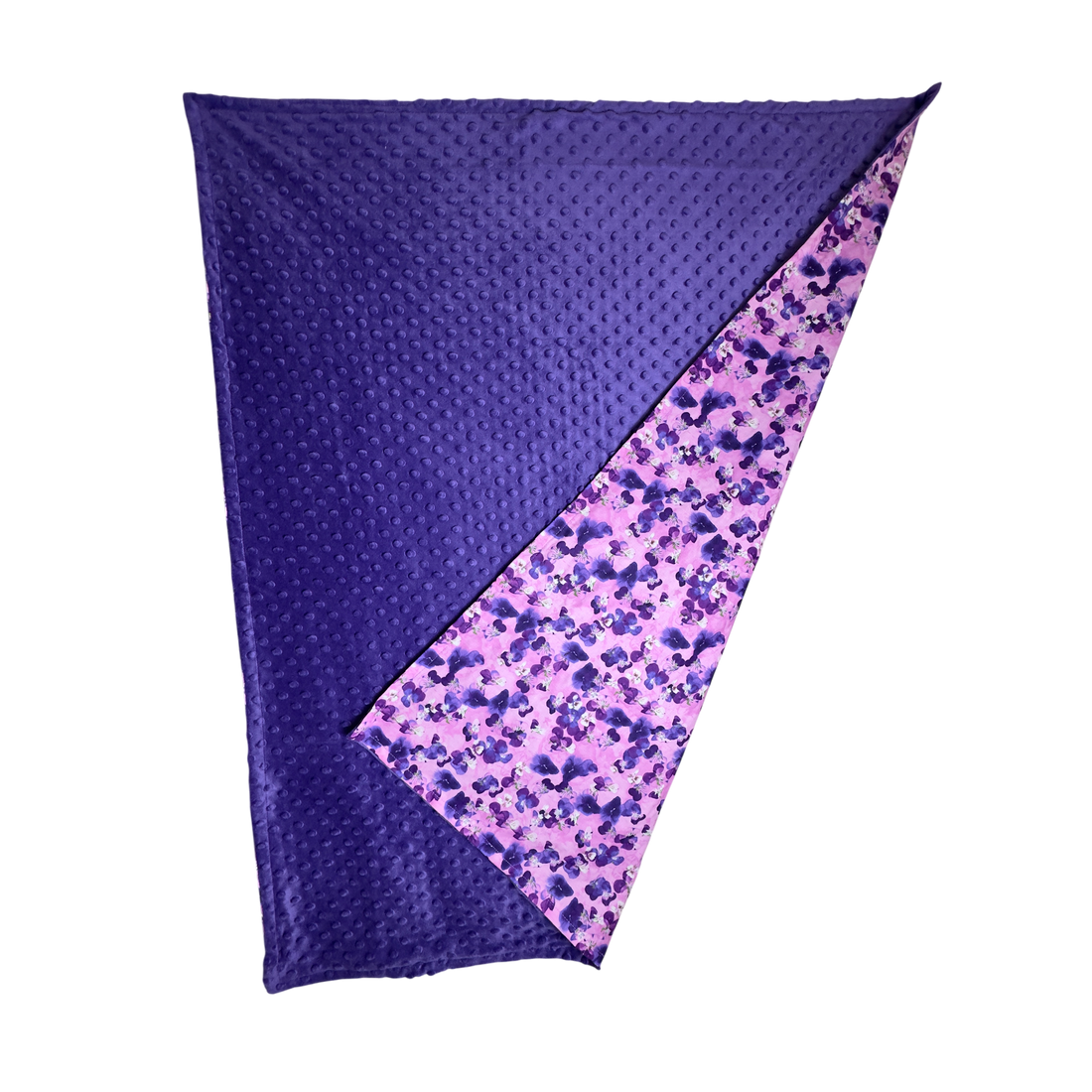 Handmade baby blanket with vibrant pink and purple cotton print and soft dotted minky backing