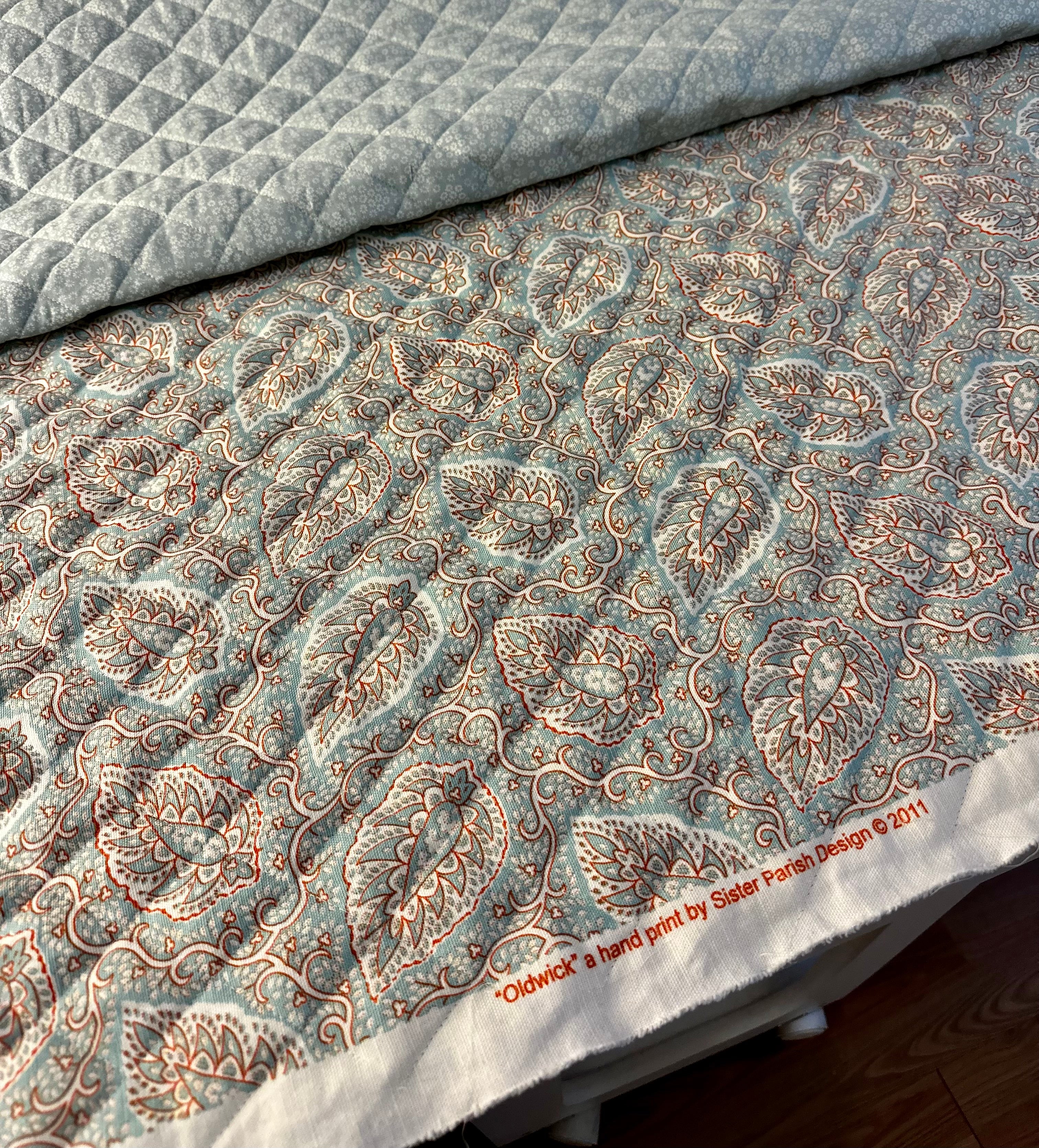 Patterned fabric with paisley design and coordinating cotton quilted with wool batting.