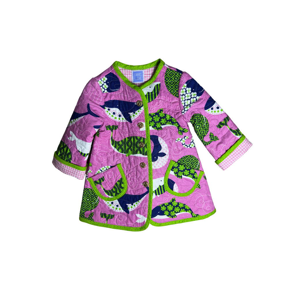 Handmade pink nautical children’s quilted coat with whale print and lime green binding