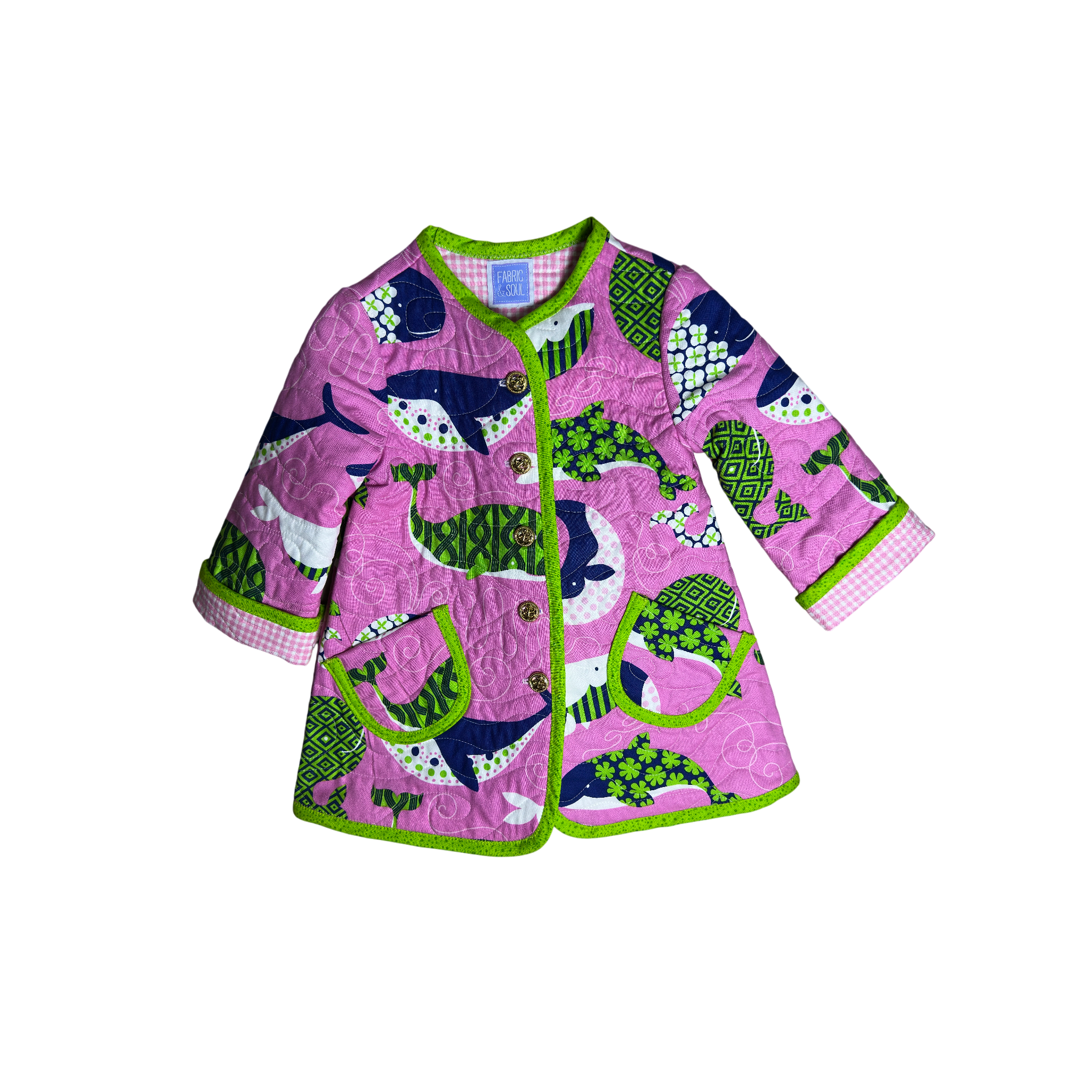 Handmade pink nautical children’s quilted coat with whale print and lime green binding