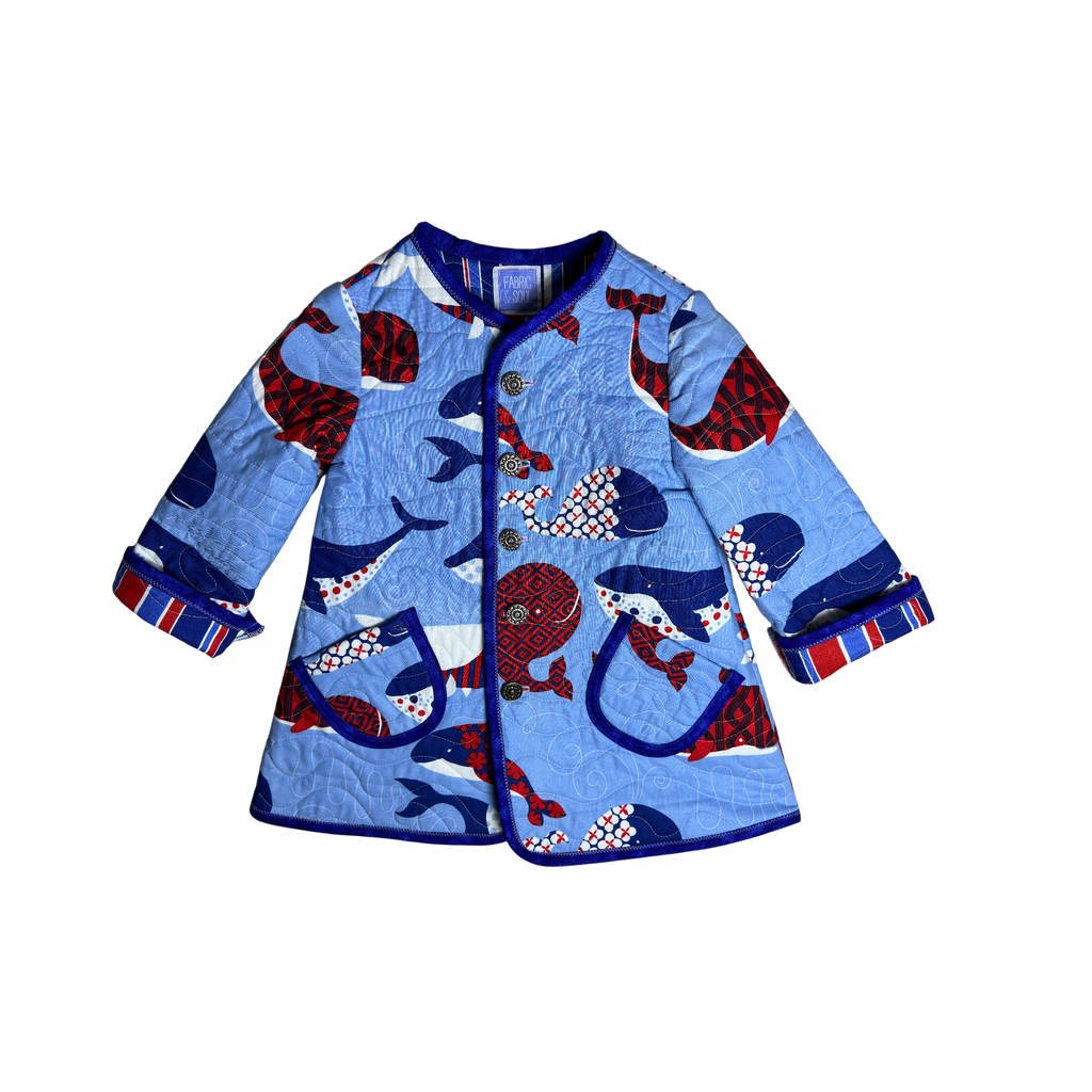 Handmade blue nautical children’s quilted coat with whale print and navy binding