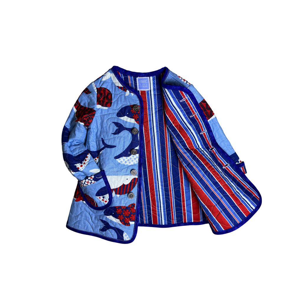 Interior striped red white and blue lining of handmade quilted child’s coat