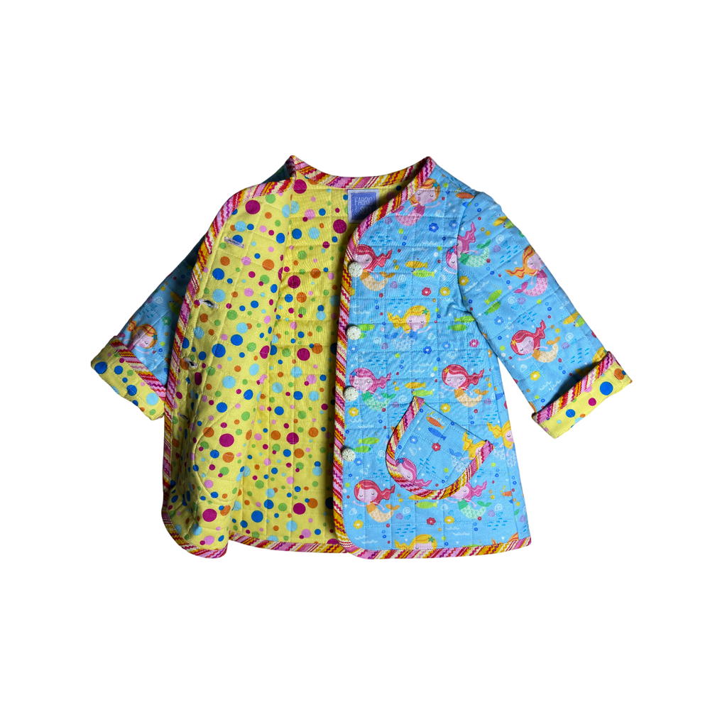 Colorful large polka dots on quilted coat lining and sand dollar-inspired buttons 