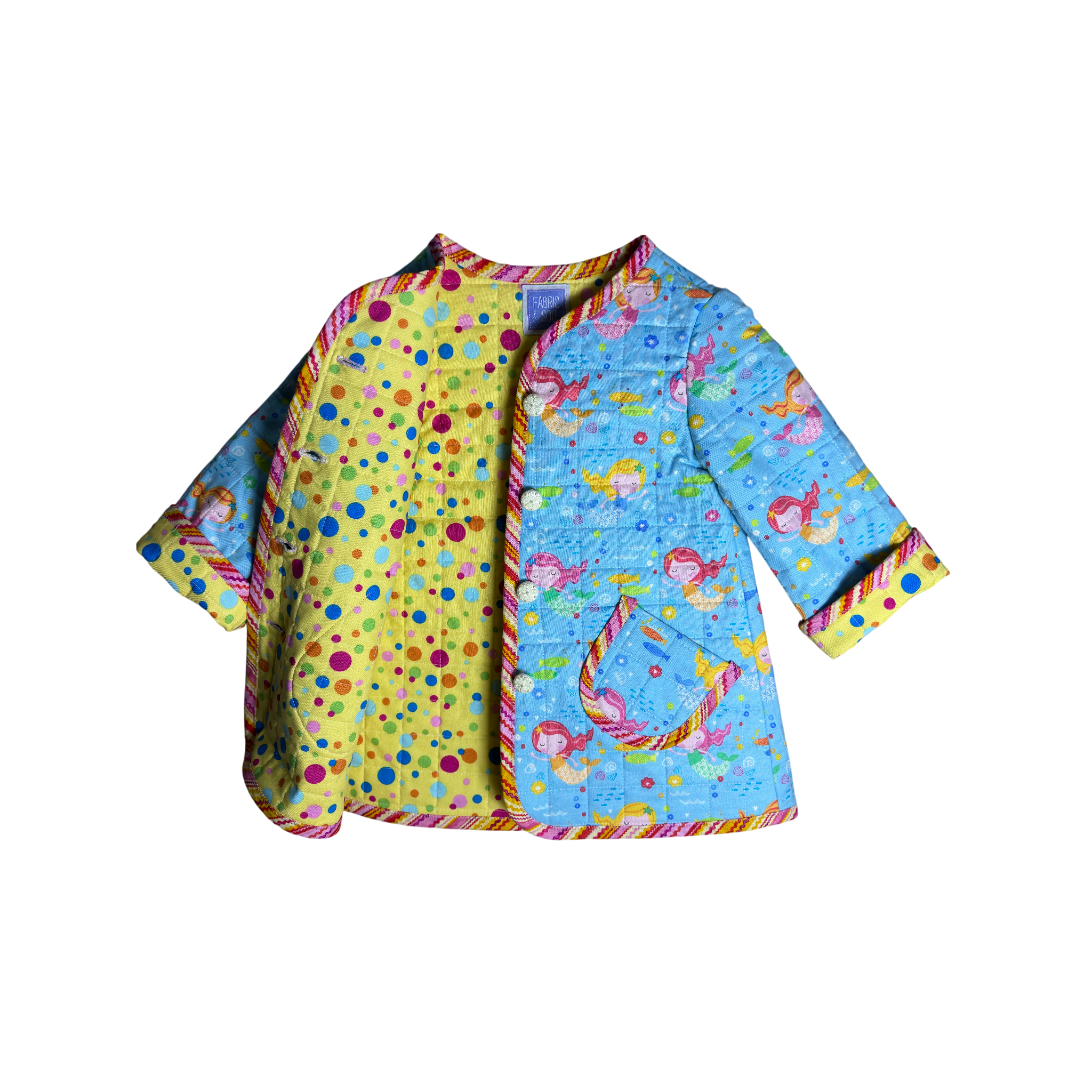 Colorful large polka dots on quilted coat lining and sand dollar-inspired buttons 