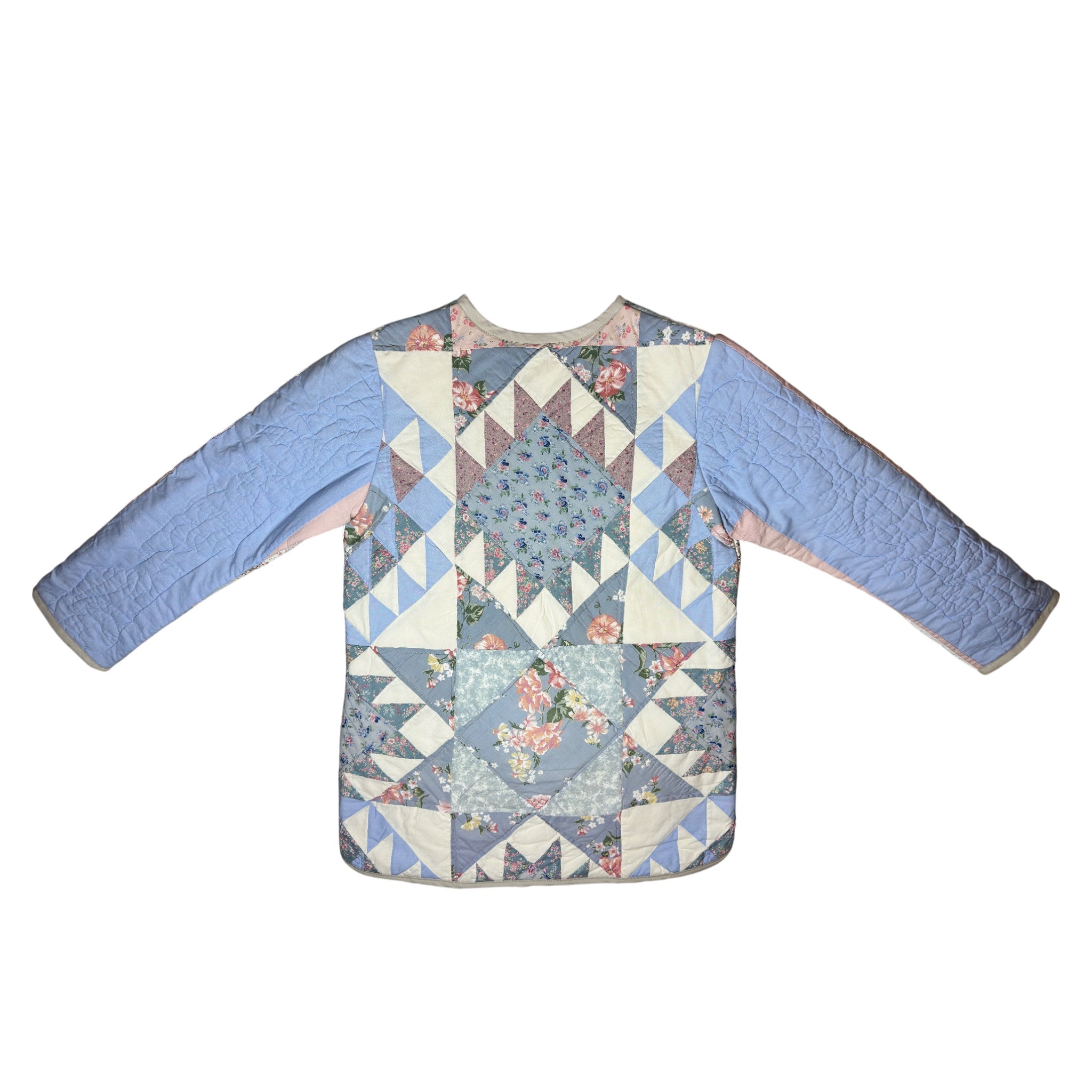 Back view of one of a kind quilted coat featuring coordinating vintage quilt design in soft blue and floral patterns