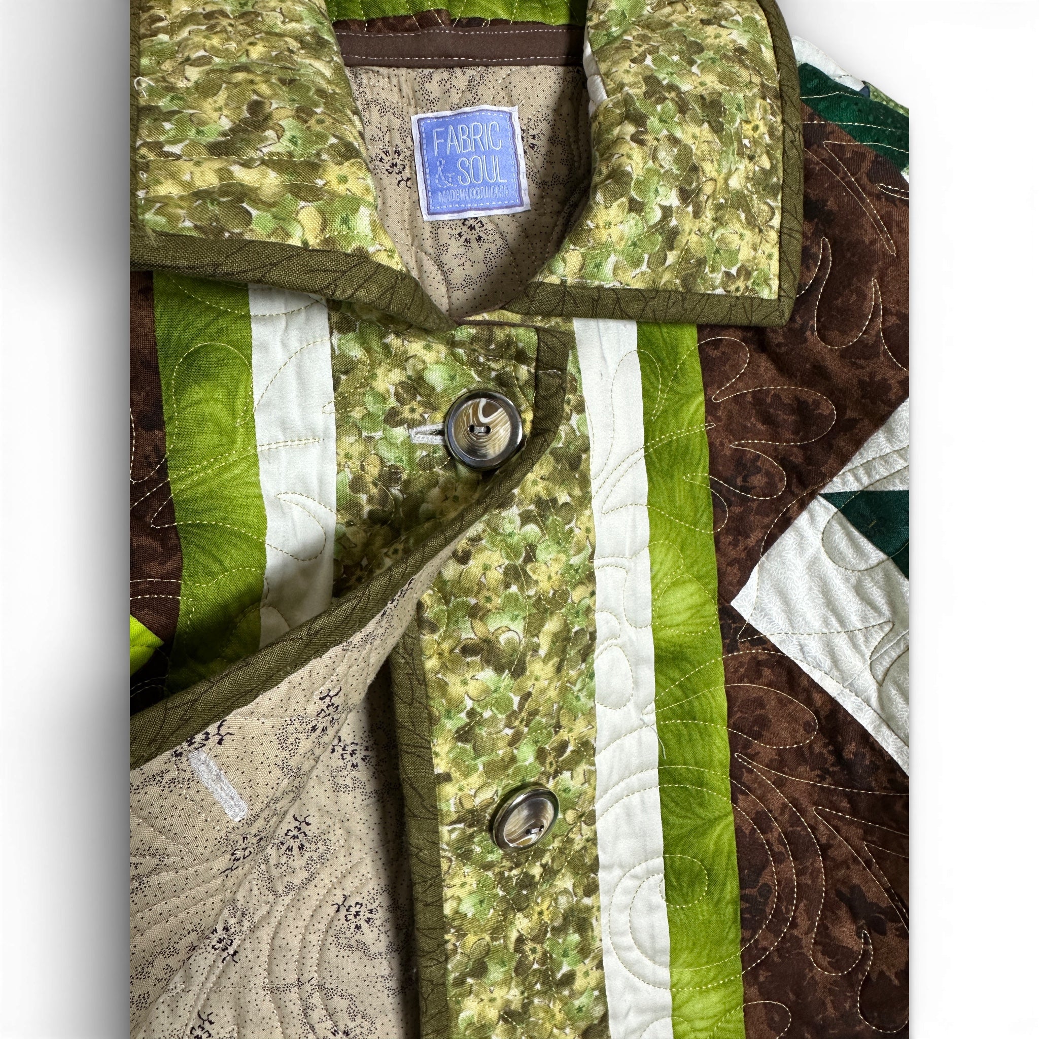 Button closure detail on handmade quilted jacket