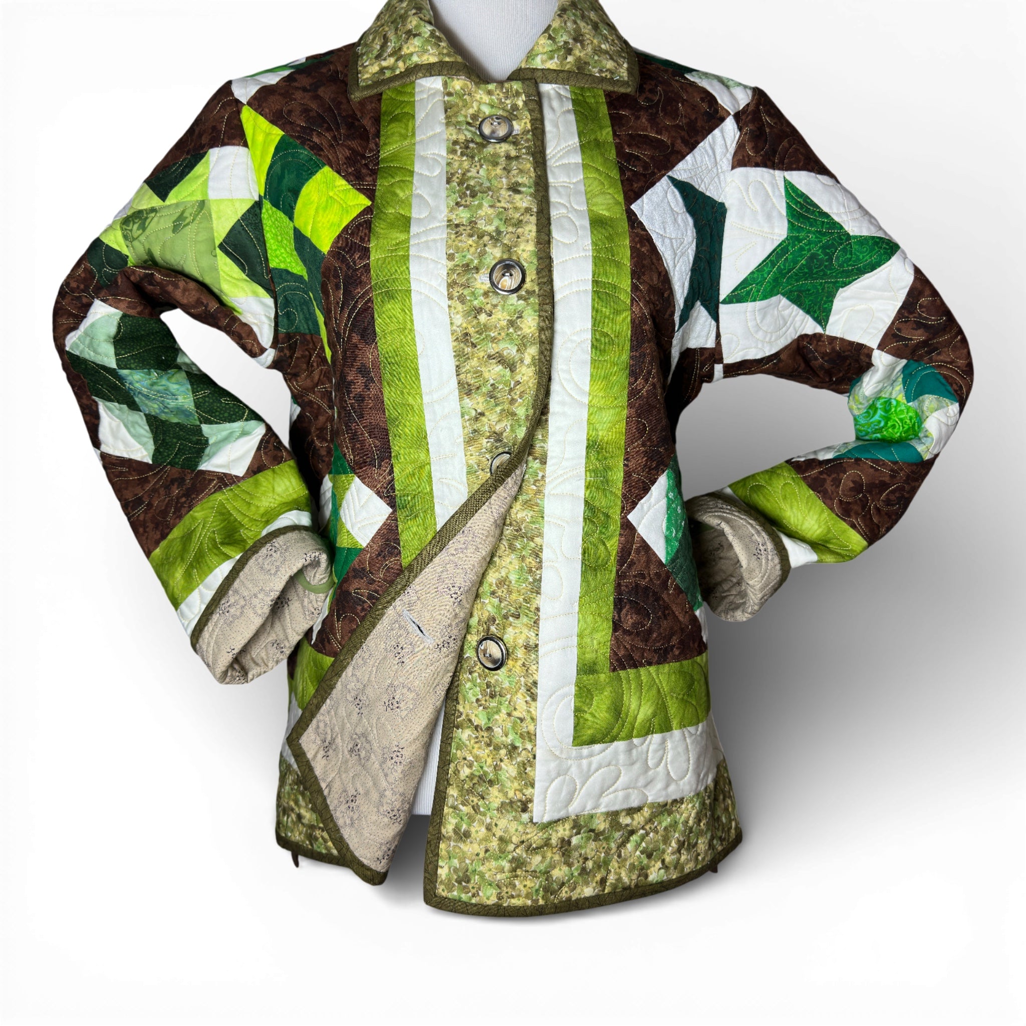 Handmade quilted coat styled with rolled sleeves on mannequin