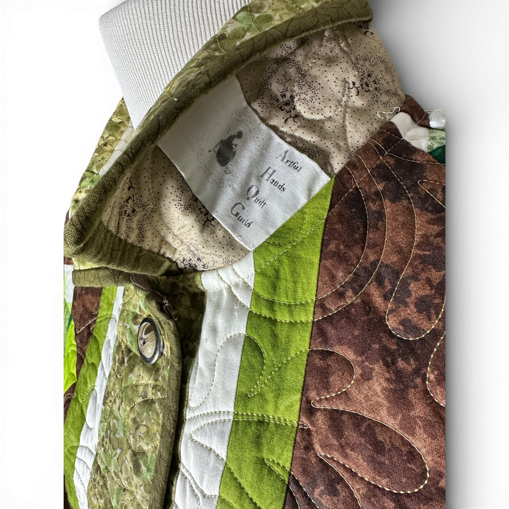 Original quilting guild tag preserved under collar of repurposed quilt coat