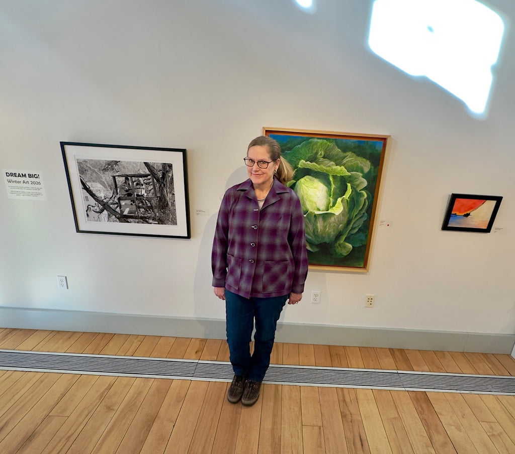 Handmade wool shirt being work in Cotuit Art Center showing vibrant plaid and style. 