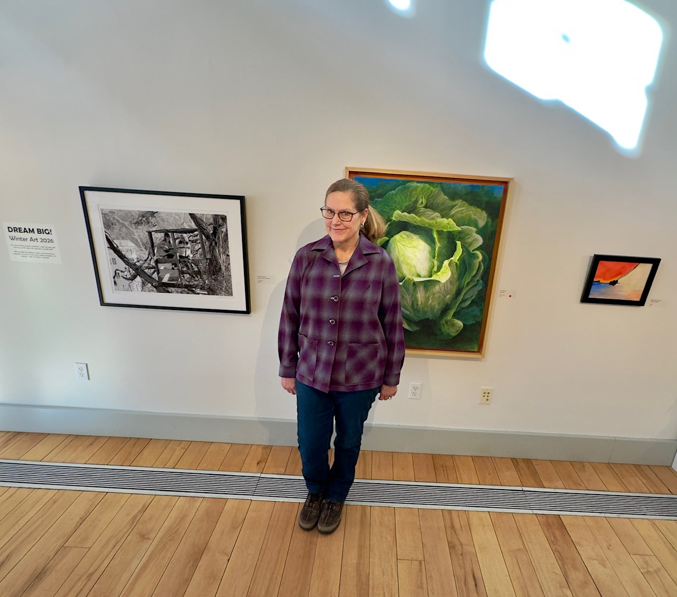 Handmade wool shirt being work in Cotuit Art Center showing vibrant plaid and style. 