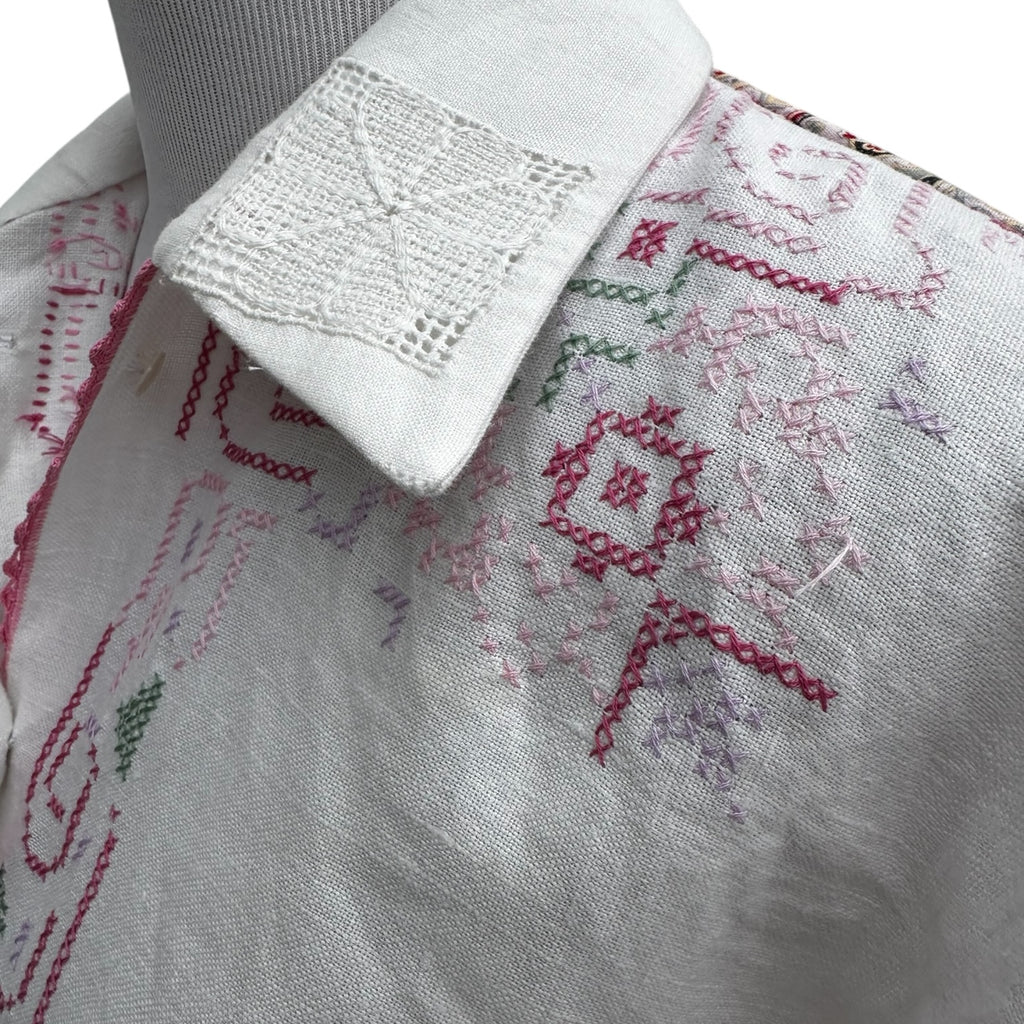 Close-up detail (collar + cross-stitch embroidery):