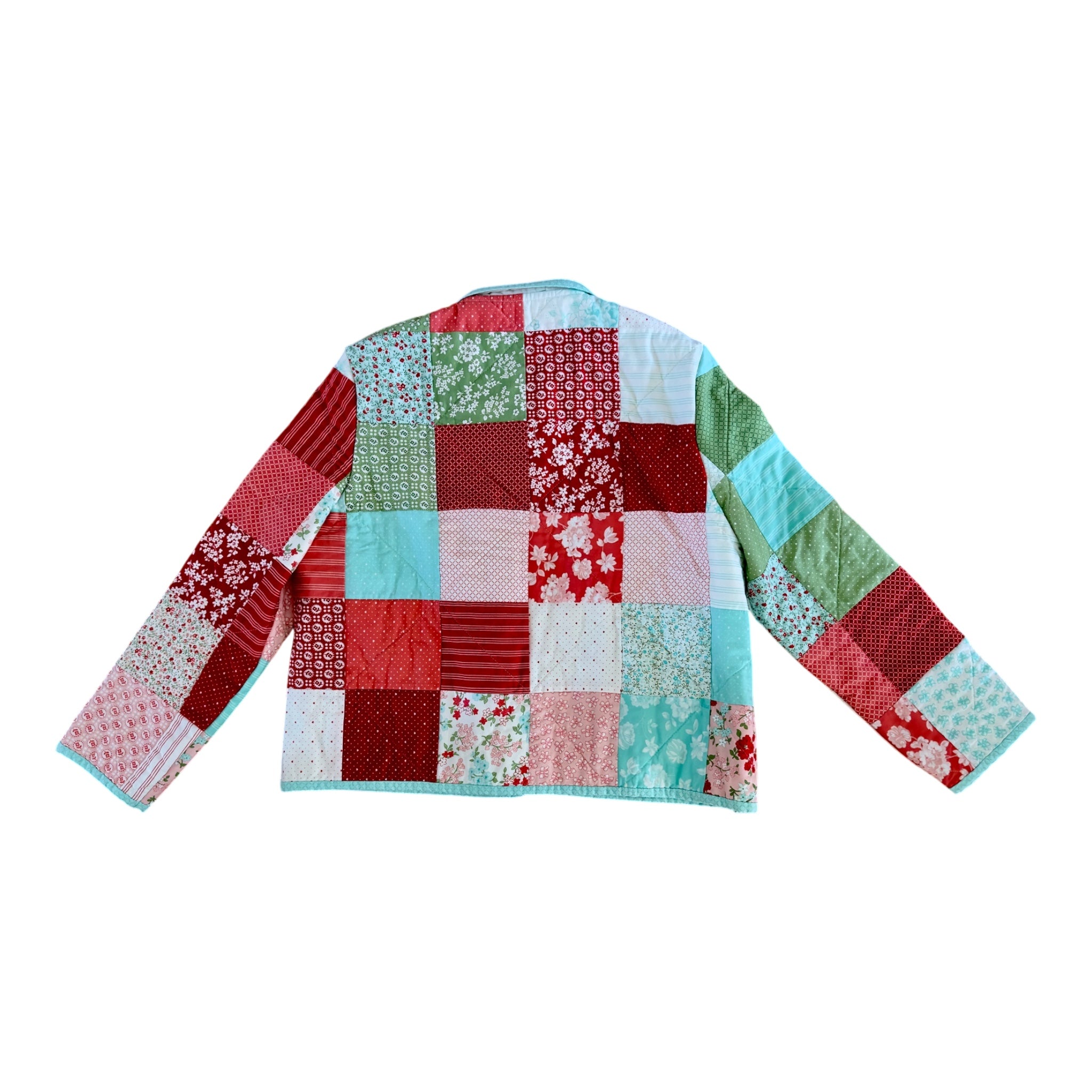 Colorful back view of patchwork jacket in reds, teal blue, green and white made by Fabric & Soul.