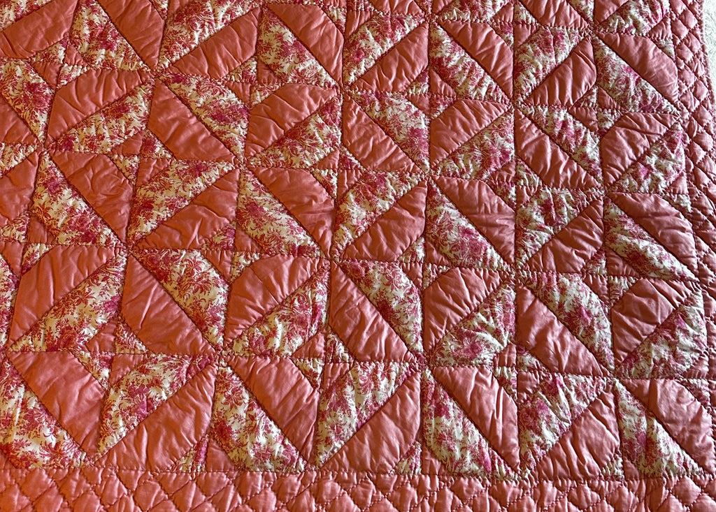 Original Chatham estate sale quilt showing pinwheel star patchwork pattern in dusty rose and pink floral toile — the source textile for the Fabric & Soul Signature Collection coats