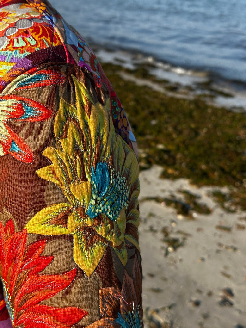 Kaffe Fassett quilted coat close-up — thread-painted sleeves, handmade by Fabric & Soul in Cotuit MA