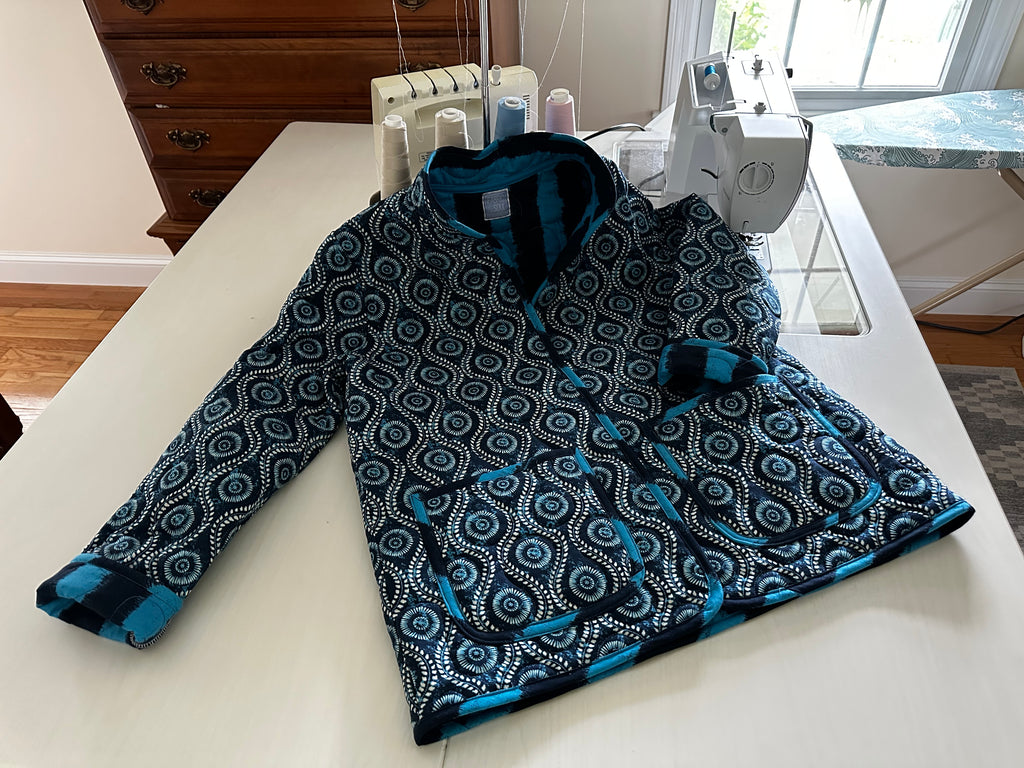 Handmade coastal blue quilted jacket laid flat, full length view, Fabric & Soul