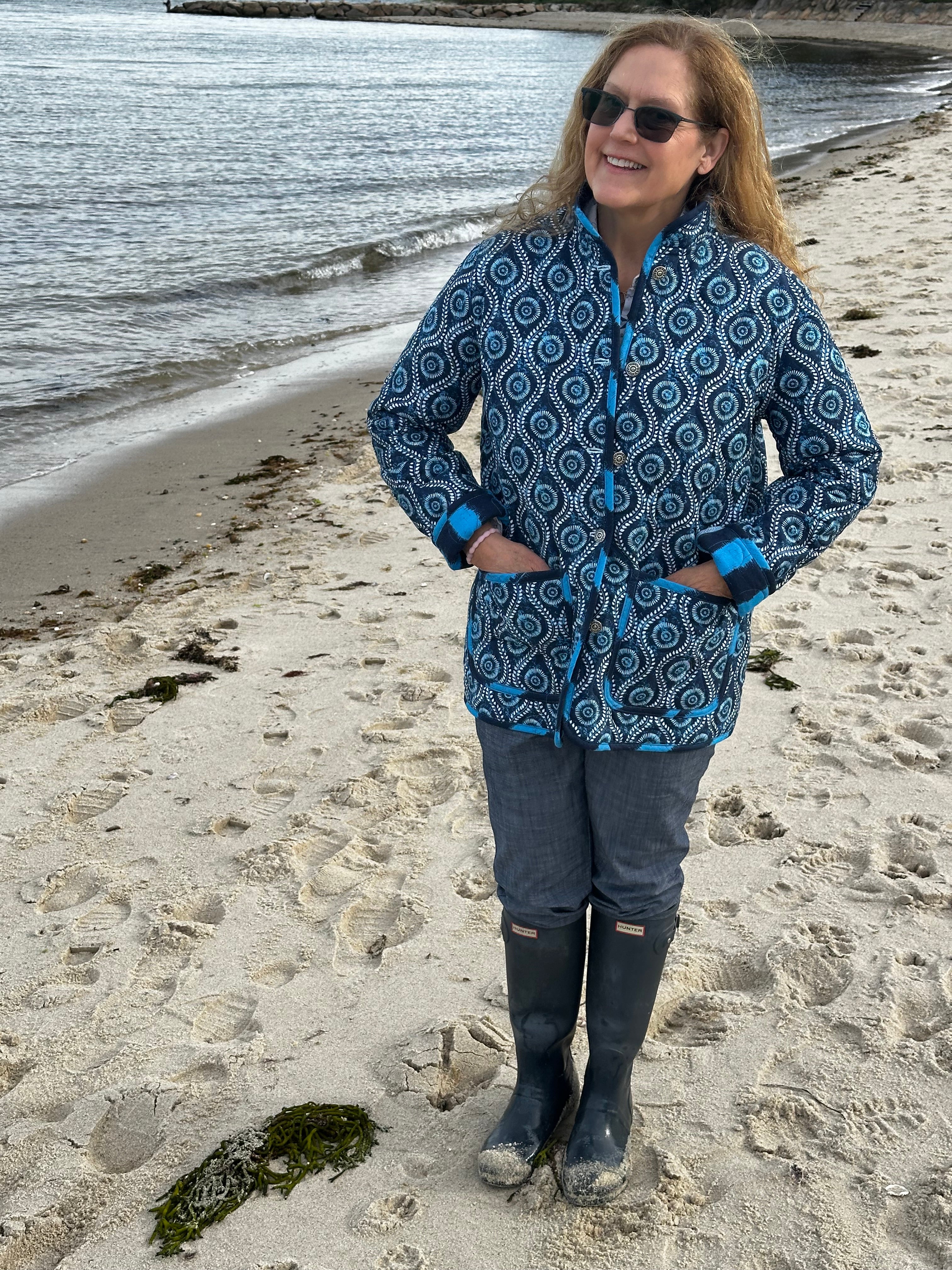 Coastal blue quilted jacket fabric and texture close-up, handmade slow fashion