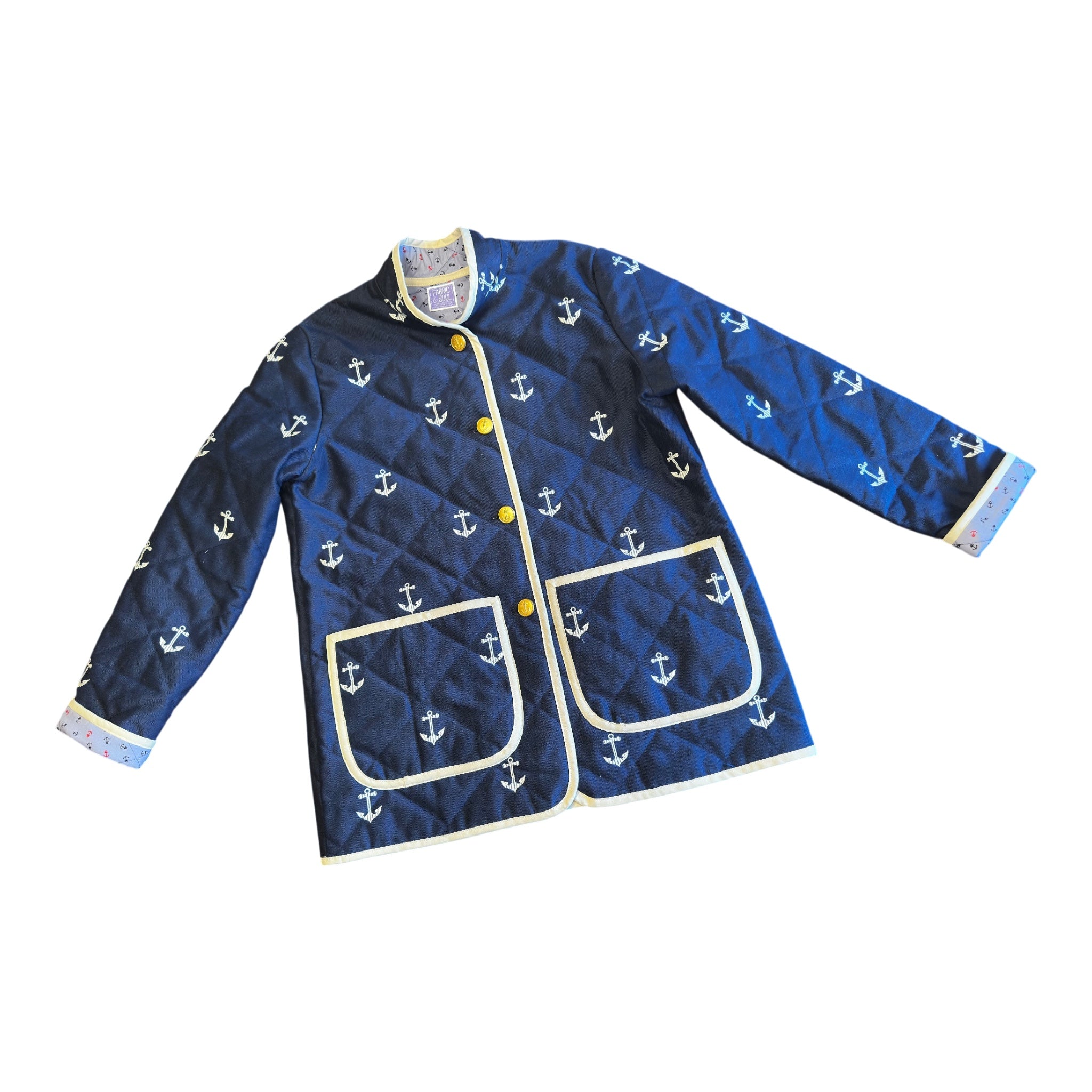 Harbor Heritage Quilted Coat – navy anchor quilted exterior with ivory binding, yellow buttons, and two front patch pockets. Handmade by Fabric & Soul in Cotuit, Cape Cod.