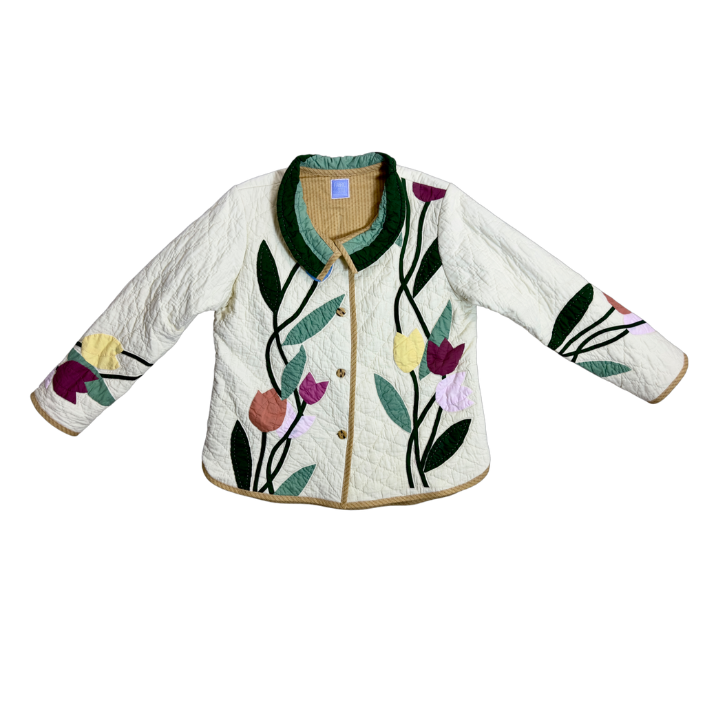 Adult wearing Blooms & Basket quilted jacket with floral design