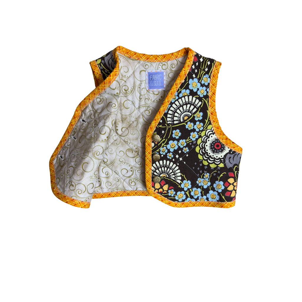 Detail of floral pattern and gold button closure with beautiful golden swirls on tan lining