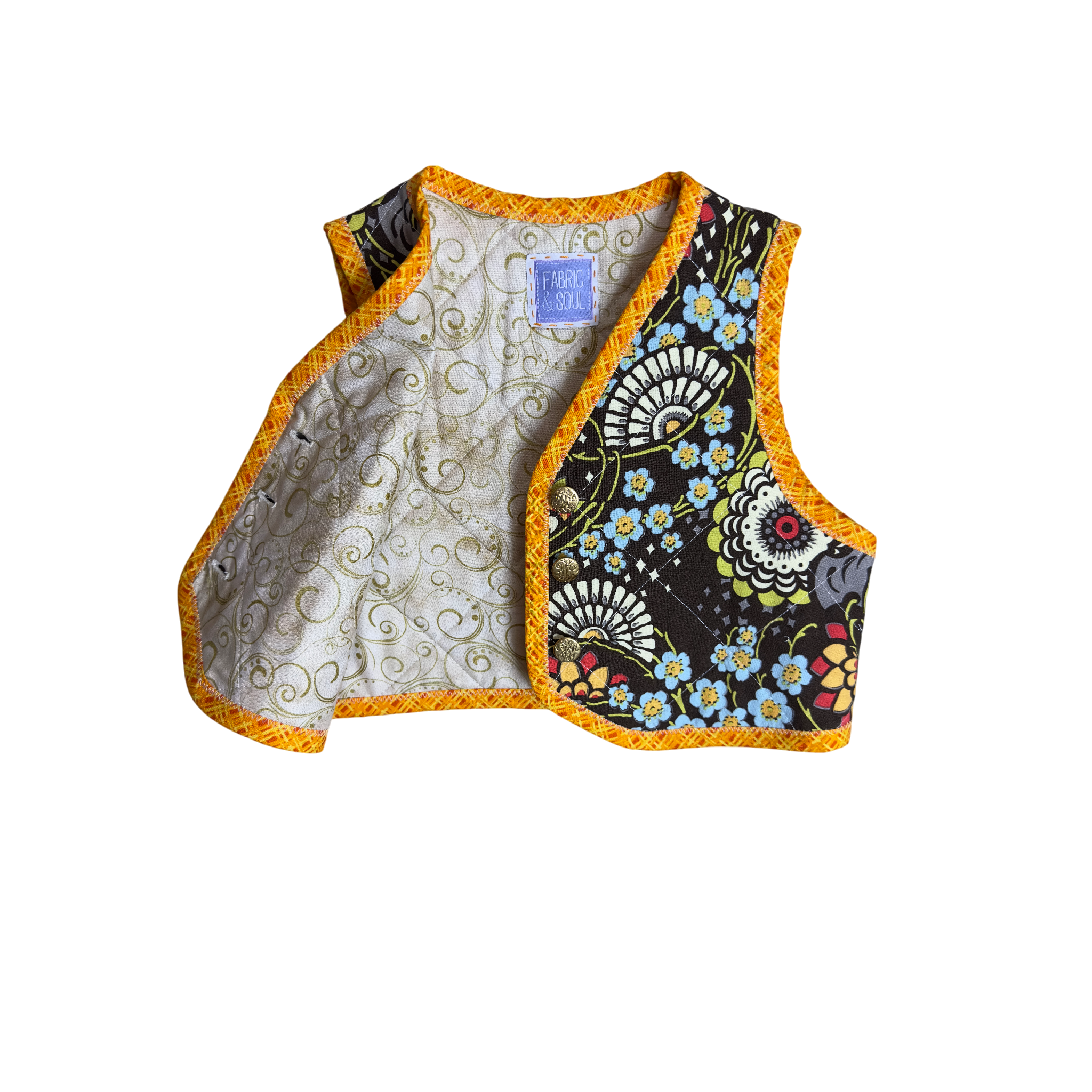 Detail of floral pattern and gold button closure with beautiful golden swirls on tan lining