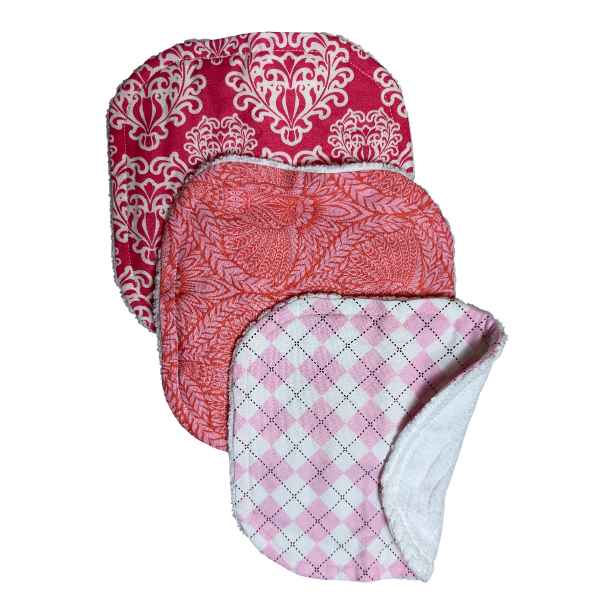 Handmade baby washcloth set of three with pink floral, orange floral, and argyle patterns on soft terry cloth