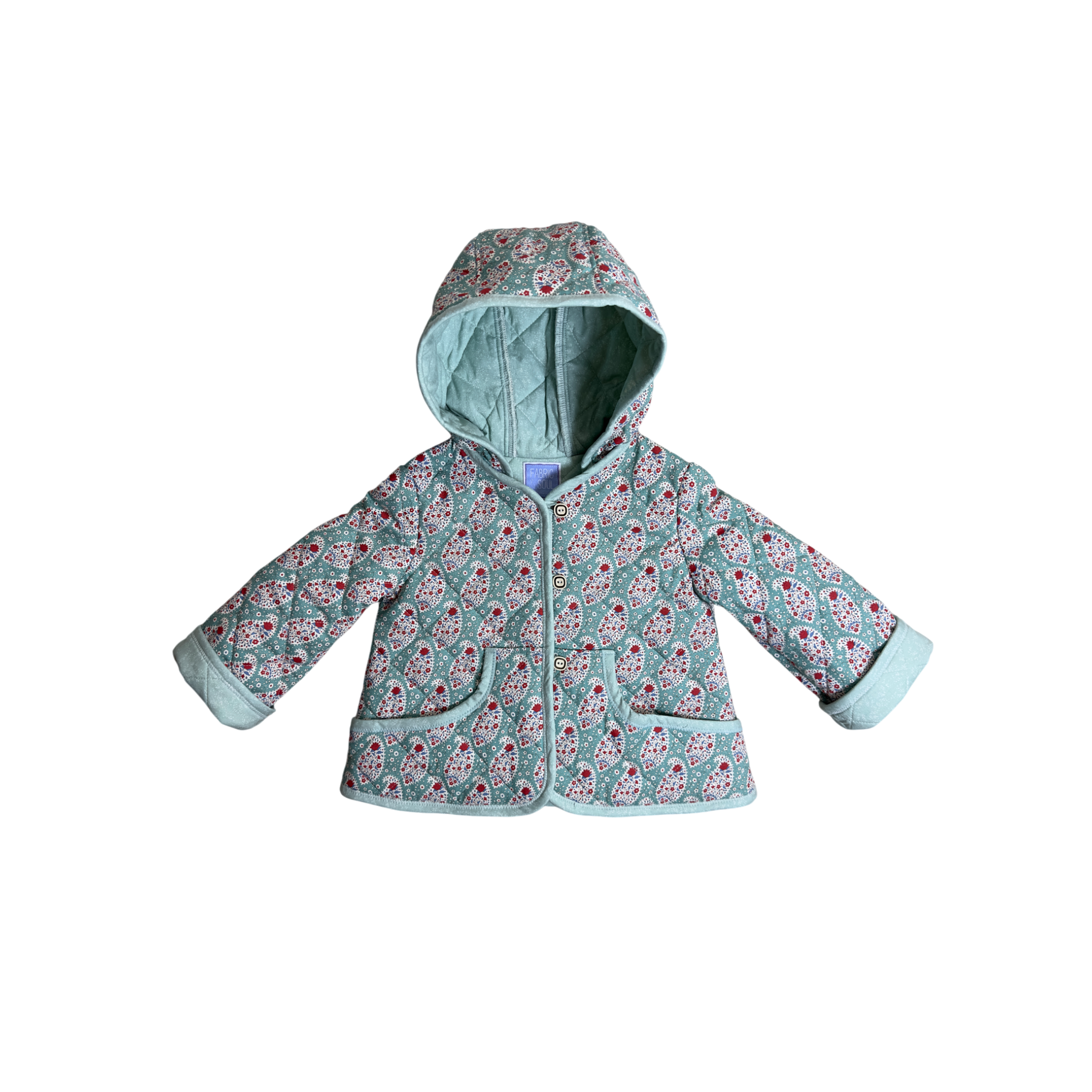 Child wearing teal paisley hooded coat with quilted wool lining