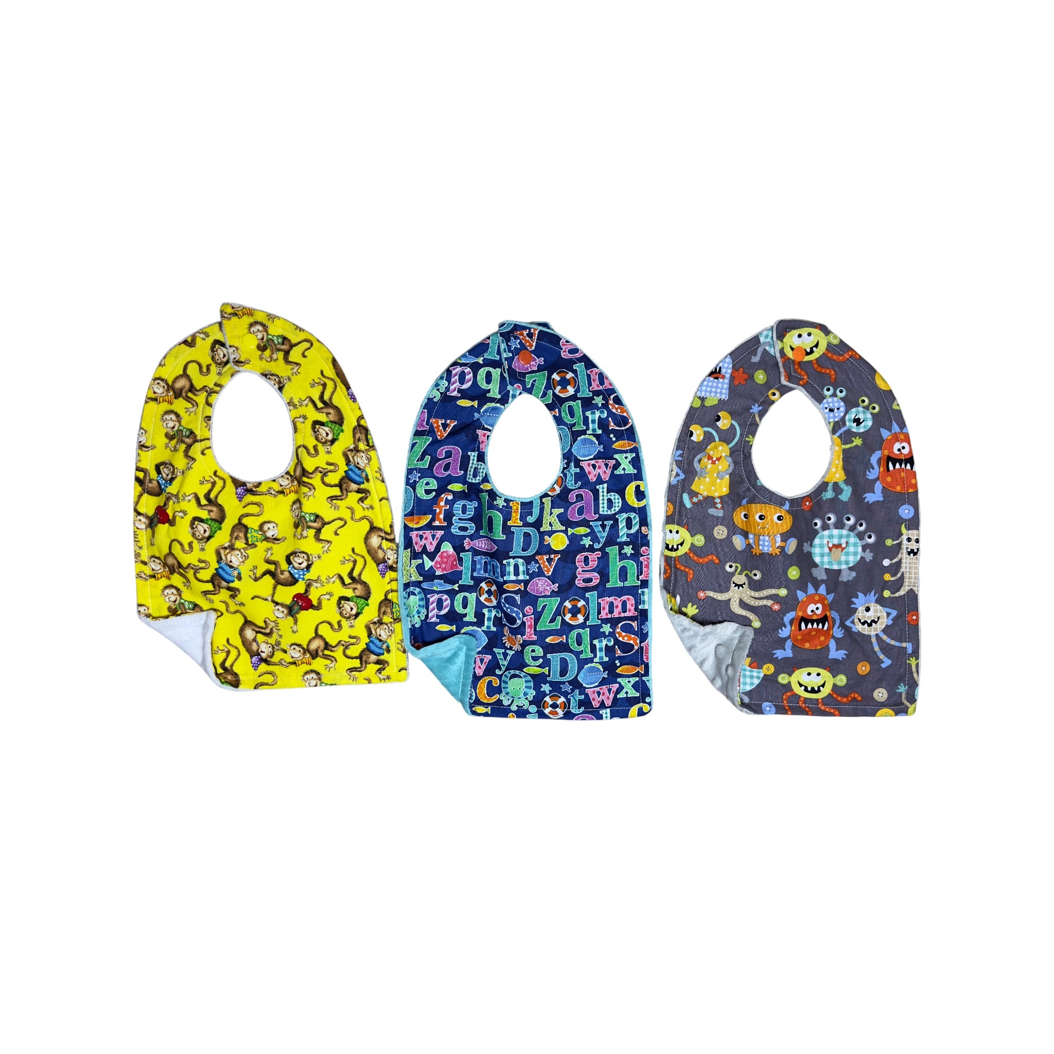 Handmade baby bib set of three with dancing monkeys, colorful alphabet letters, and whimsical monsters on quilting cotton