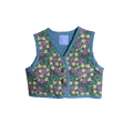 Front view of vest with gold colored buttons 