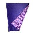 Handmade baby blanket with vibrant pink and purple cotton print and soft dotted minky backing