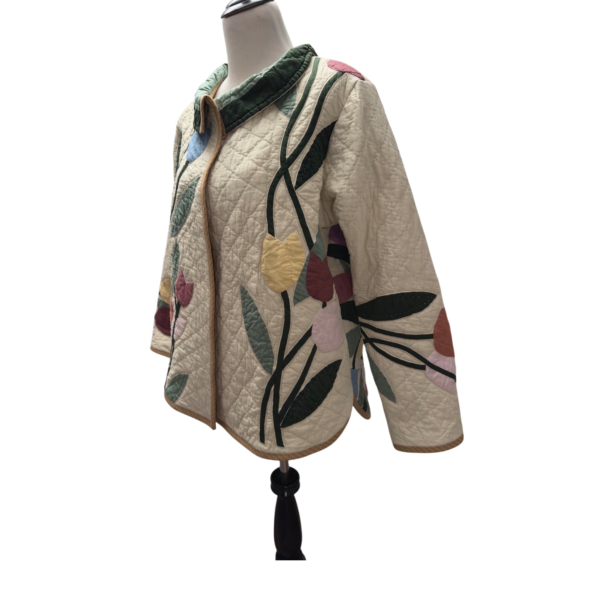 Quilted jacket with floral patterns on a mannequin against a white background handmade by Fabric & Soul