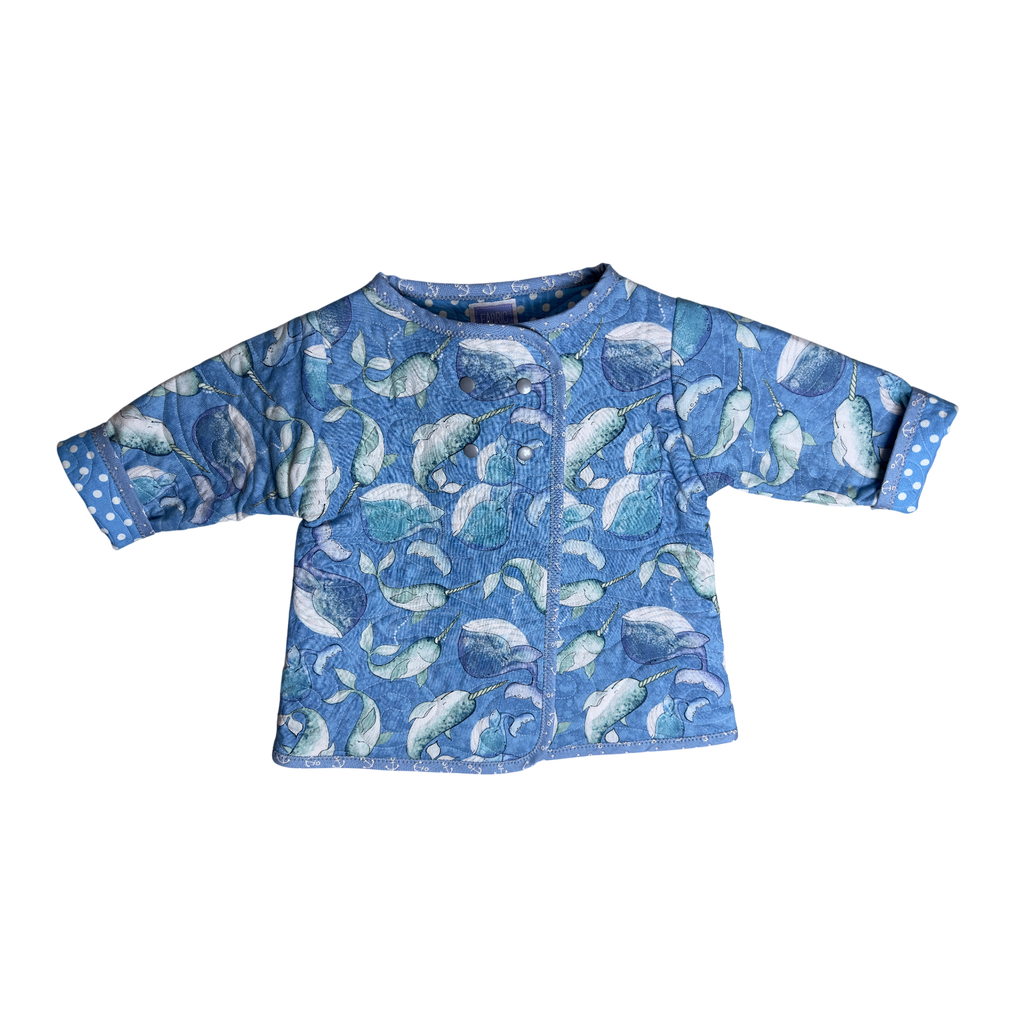 Front view blue quilted coat with narwhal print