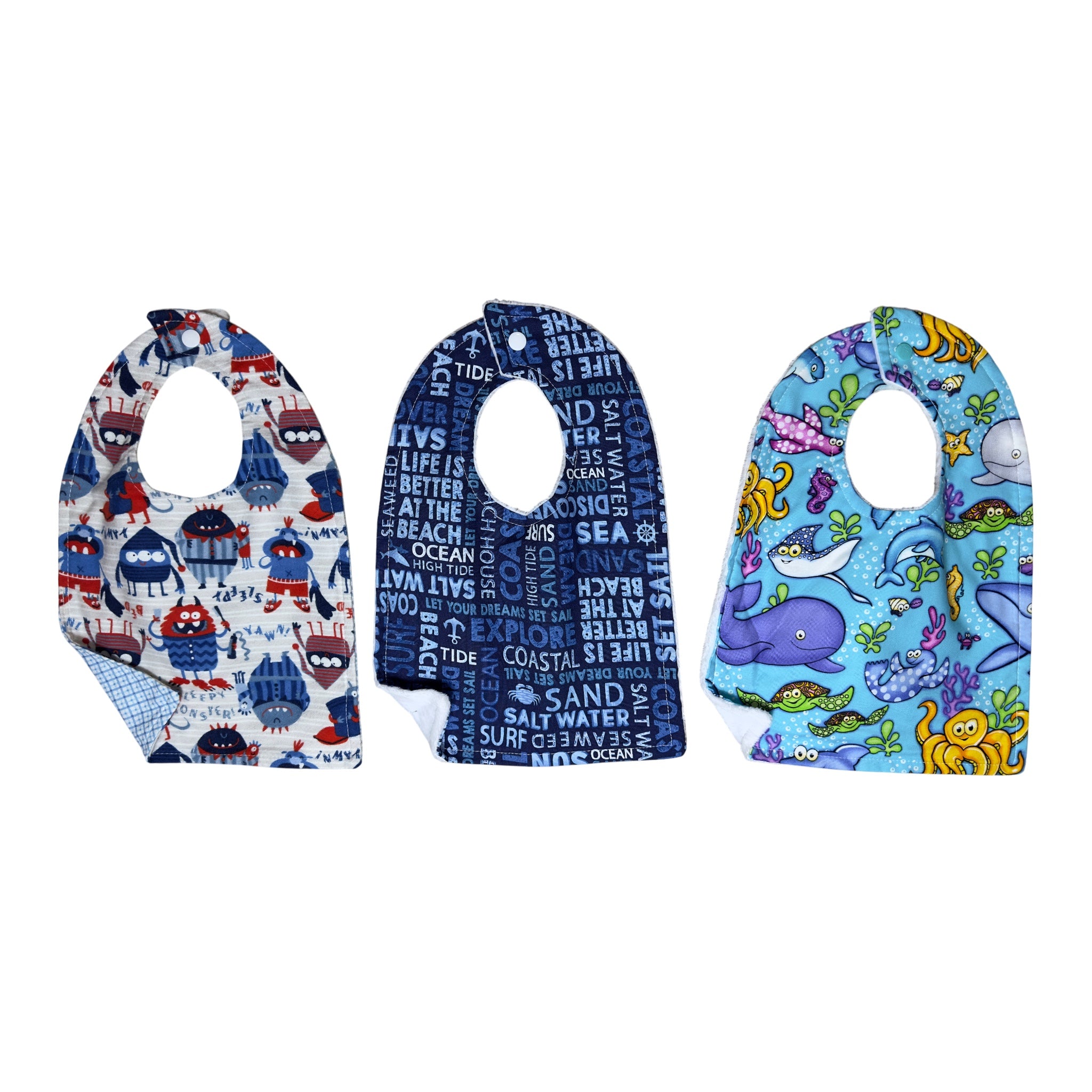 Handmade baby bib set of three with playful monsters, beach words, and colorful ocean creatures on quilting cotton with soft white backing