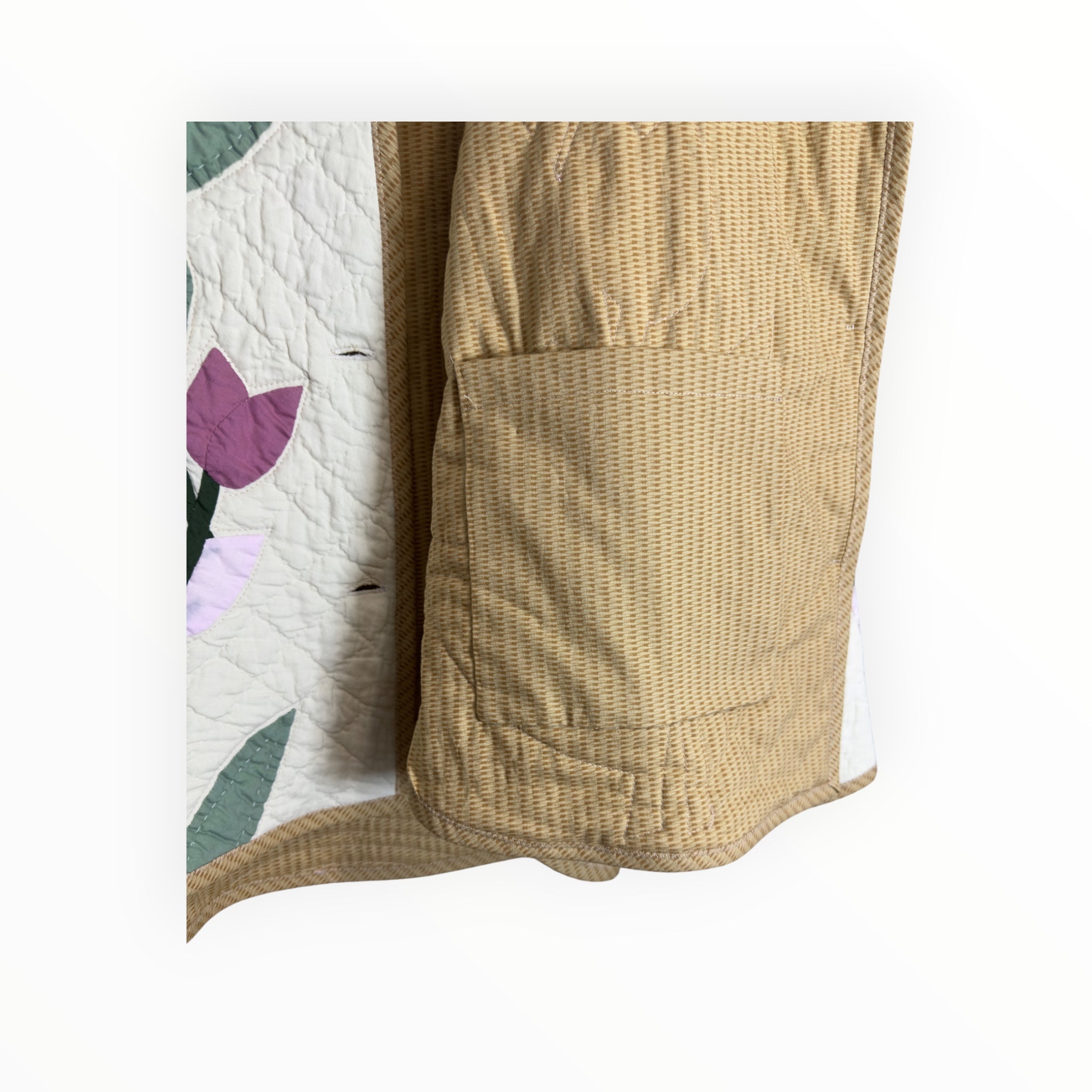 Detail of quilted stitching, pocket,  floral fabric and lining