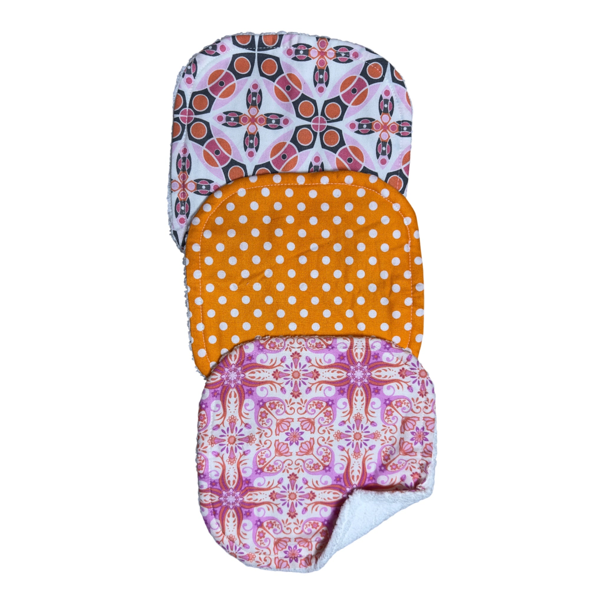 Handmade baby washcloth set of three with orange polka dots, geometric floral, and kaleidoscope designs on soft terry cloth