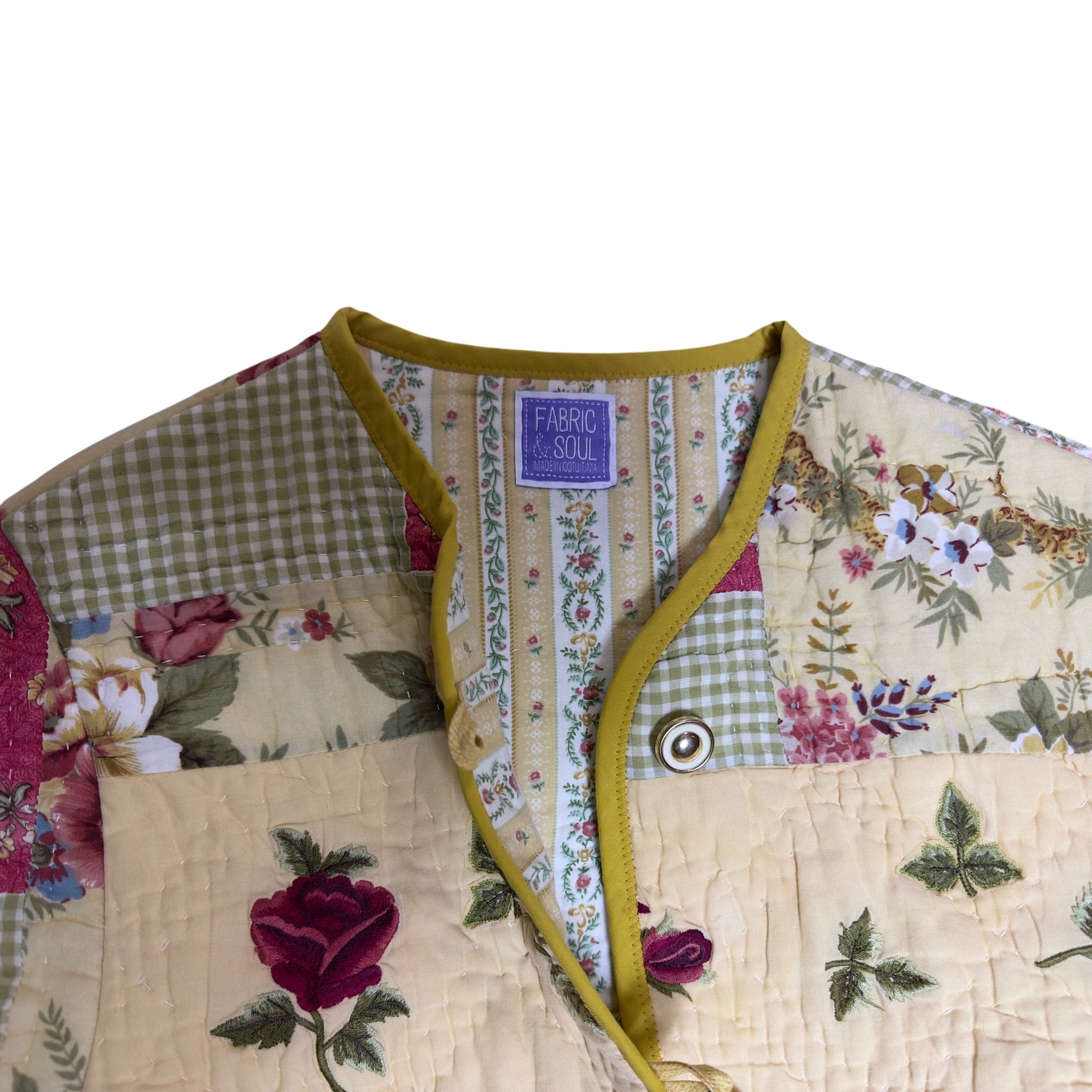 Inside view of Vintage quilted jacket made from repurposed cotton quilt with detail of gold and cream buttons, handmade coat by Fabric and Soul